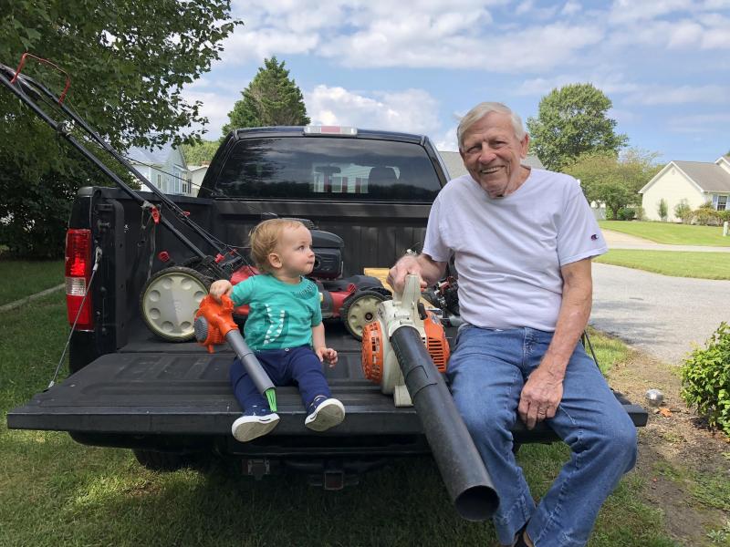 Grandson Logan (son of Brad and Julie Egolf) and Pop Pop John Forestieri take a tailgate break after some leaf blowing. SUBMITTED PHOTO
